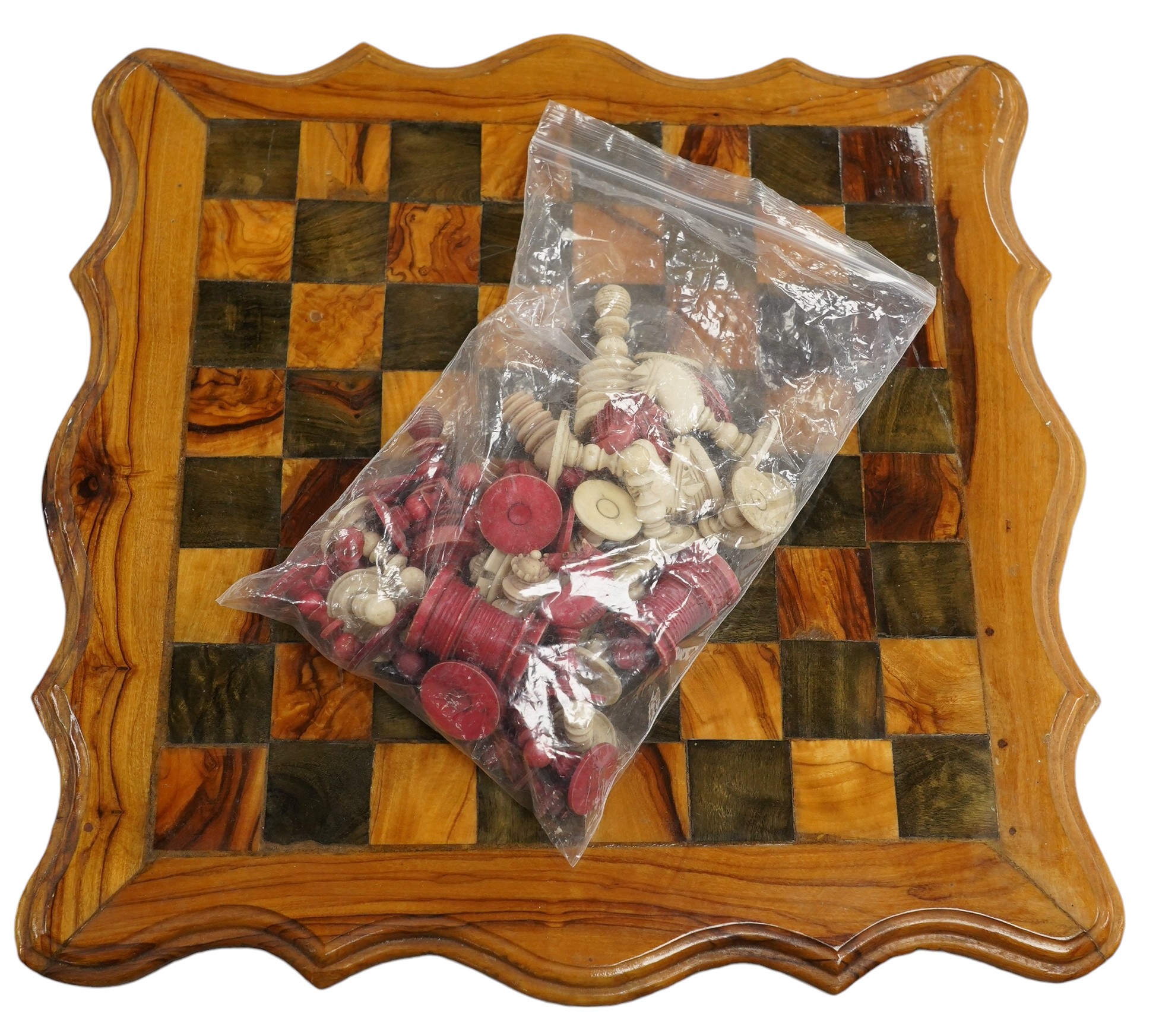 A 19th century stained and natural bone chess set with board, 34cm x 34cm. Condition - fair, some damage to some chess pieces